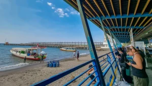 Passengers waiting for departure at Bangsal Lombok public ferry terminal, gateway to the Gili Islands and Lombok mainland.