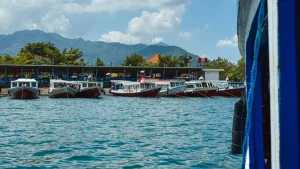 Traditional wooden boats (jukung) lined up at Bangsal Lombok, local maritime scene near the fast boat route from Padang Bai to Bangsal Lombok.