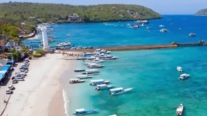 Banjar Nyuh Harbor coastline with multiple fast boats anchored, active docking area for fast boat transfers.