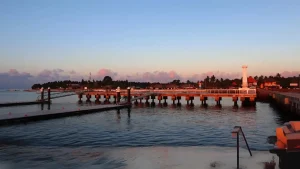 Beautiful sunset view over Banjar Nyuh Harbor in Nusa Penida, serene evening atmosphere at the island's port.