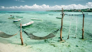 Relaxing beach swing overlooking a calm bay in Nusa Ceningan, perfect spot for a serene moment by the sea.