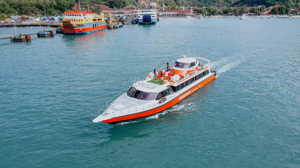 Ganggari Express departing slowly from Padang Bai Harbor, Bali, beginning a scenic voyage to Gili Trawangan and Lombok.