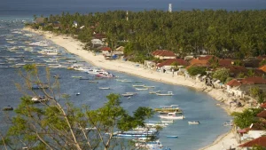Aerial view of Jungut Batu Beach Nusa Lembongan, showing the coastline, hotels, and boat activity.