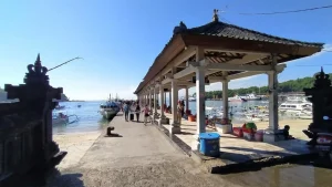 Clean concrete dock at Padang Bai Harbor bathed in morning sun, organized and bright departure point for island hopping.