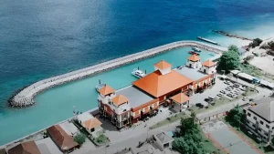 Rear aerial view of Sampalan Harbor complex showing the terminal and covered dock, modern port infrastructure in Nusa Penida.