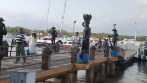 Passengers disembarking from a fast boat at Serangan Harbor, arriving in Bali after a trip from the Gili Islands or Nusa Penida.