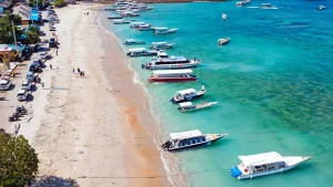 Toyapakeh Harbor with fast boats, snorkeling boats, and traditional fishing vessels, active multi-use port in Nusa Penida.